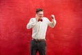 Portrait of puzzled man talking by phone a red background Royalty Free Stock Photo