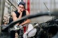Portrait of puzzled mechanic male with confused expression leaning on car engine, struggling to identify source of Royalty Free Stock Photo
