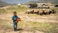 Portrait of Qashqai Turkish girl with a group of goats, Shiraz, Iran