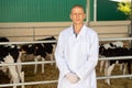 Portrait of a qualified young male veterinarian standing on a livestock farm Royalty Free Stock Photo