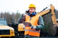 Portrait of a quarry worker standing in front of excavator Royalty Free Stock Photo