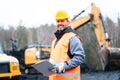 Portrait of a quarry worker standing in front of excavator Royalty Free Stock Photo