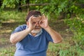 Portrait of senior making gesture like looking through binocular