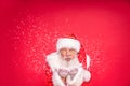 Portrait of real Santa Claus blowing in snow Royalty Free Stock Photo