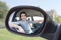 Portrait through the rear-view mirror of an attractive man in hi Royalty Free Stock Photo