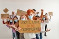portrait of rebellious redhead woman standing with cardboard asking not to be quarantined