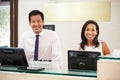 Portrait Of Reception Staff At Hotel Front Desk Royalty Free Stock Photo