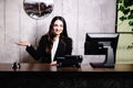 Portrait of receptionist at desk in lobby. Banner design. Friendly concierge at hotel reception behind the counter