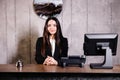 Portrait of receptionist at desk in lobby. Banner design. Friendly concierge at hotel reception behind the counter