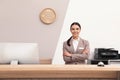 Portrait of receptionist at desk in hotel