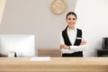 Portrait of receptionist at desk in hotel