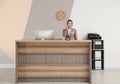 Portrait of receptionist working at desk in hotel Royalty Free Stock Photo