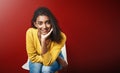 Portrait, recruitment or Indian girl in waiting room for hr meeting, help or career choice advice on red background Royalty Free Stock Photo