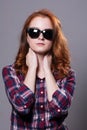 Portrait of a red-haired beautiful woman wearing sunglasses. Royalty Free Stock Photo