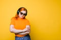 Portrait of a red-haired girl in big headphones and sunglasses Royalty Free Stock Photo