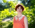 Portrait of a red-haired happy girl in park