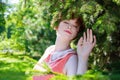 Portrait of a red-haired happy girl in park