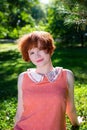 Portrait of a red-haired happy girl in park