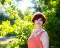 Portrait of a red-haired happy girl in park