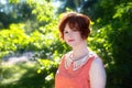 Portrait of a red-haired happy girl in park