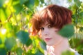 Portrait of a red-haired happy woman in park