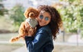 Portrait of red haired little dog, mini poodle with curly woman look at camera and smile in Park. Pet looks like owner Royalty Free Stock Photo