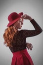 Portrait of a red-haired young woman  in a red hat Royalty Free Stock Photo