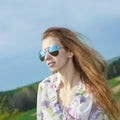 Portrait of red long-haired beautiful girl in  sunglasses Royalty Free Stock Photo