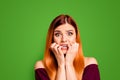 Portrait of red straight-haired attractive cute nice scared worried young girl, biting nails. Isolated over bright vivid Royalty Free Stock Photo