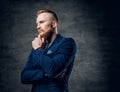 Redhead bearded hipster male dressed in a blue jacket. Royalty Free Stock Photo