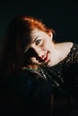 Portrait of redhead female singer woman in sparkly evening dress holding microphone. Singer at microphone. Woman singing Royalty Free Stock Photo