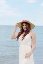 Portrait redhead woman at beach wearing hat