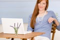 Portrait redhead woman with laptop on terrace