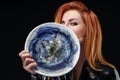 Portrait of redhead woman posing with creative plate