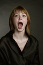 Portrait of redheaded screaming girls with mouth wide open Royalty Free Stock Photo