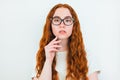 Portrait of redheaded woman in eyeglasses on white backgroung, learning and teaching concept