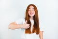 Portrait of redheaded young smiling woman looking natural standing on isolated white backgroung showing like sign, body language