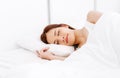 Portrait of relaxed beautiful Asian woman sleeping on white bed in the bedroom in the morning. Lady enjoys sweet dreams, good rest Royalty Free Stock Photo