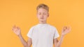 Portrait of relaxed boy meditating with closed eyes