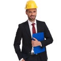 Portrait of relaxed businessman wearing safety helmet holding bl Royalty Free Stock Photo