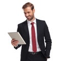 Portrait of relaxed and joyful businessman looking at tablet