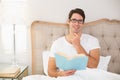 Portrait of relaxed man reading book in bed Royalty Free Stock Photo