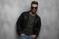 Portrait of relaxed man wearing leather jacket and sunglasses smiling Royalty Free Stock Photo