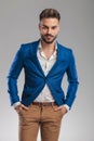 Portrait of relaxed smart casual man wearing a blue suit