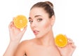 Portrait of relaxed woman holding two halves of orange Royalty Free Stock Photo