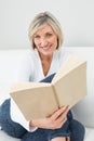 Portrait of a relaxed woman reading book Royalty Free Stock Photo