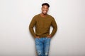 Relaxed young black man smiling against gray background Royalty Free Stock Photo