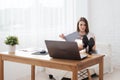 Portrait of a relaxed young businesswoman sitting with legs on desk in office. Royalty Free Stock Photo