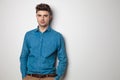 Portrait of relaxed young casual man in blue shirt standing Royalty Free Stock Photo