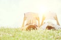 Relaxed young couple reading books while lying on grass against sky Royalty Free Stock Photo